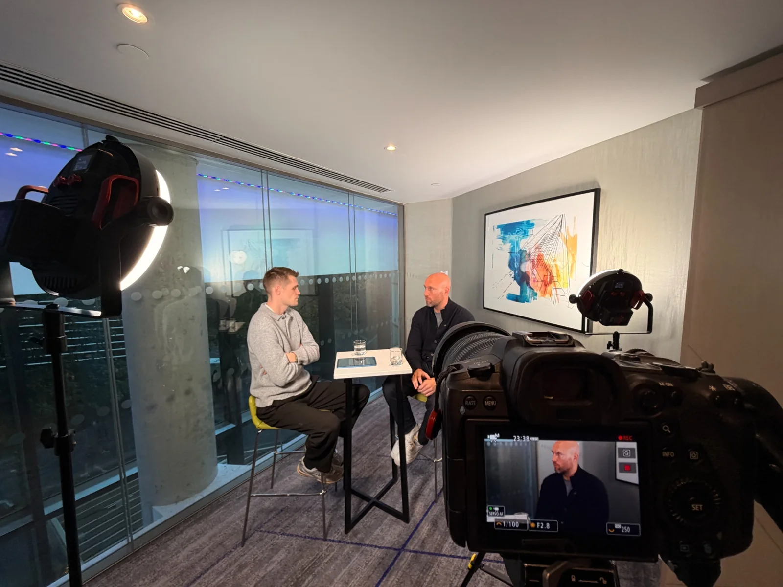 Professional camera and lighting setup recording a media interview